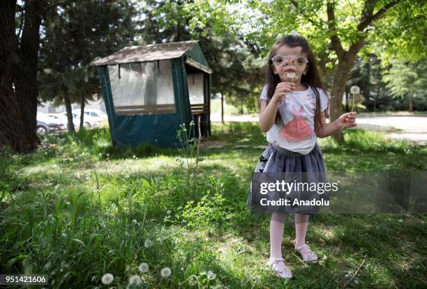 Year-old Elif Ada, who was born with a visual impairment due to a genetic disease poses for a photo with her newly produced eyeglass using 3D...