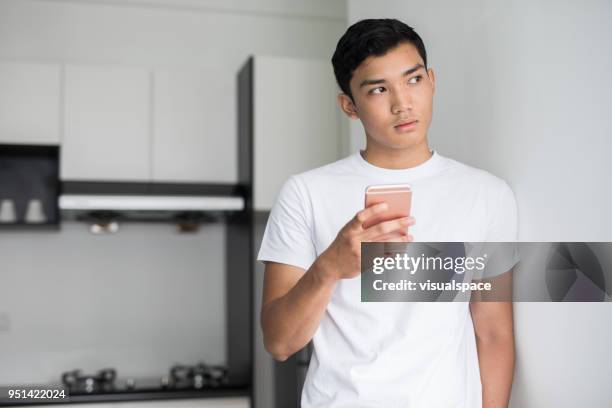 young man with a smartphone - cell phone confused stock pictures, royalty-free photos & images