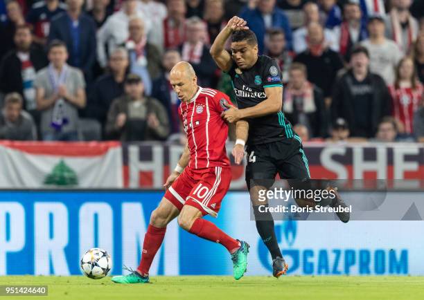 Arjen Robben of FC Bayern Muenchen is challenged by Casemiro of Real Madrid during the UEFA Champions League Semi Final First Leg match between...