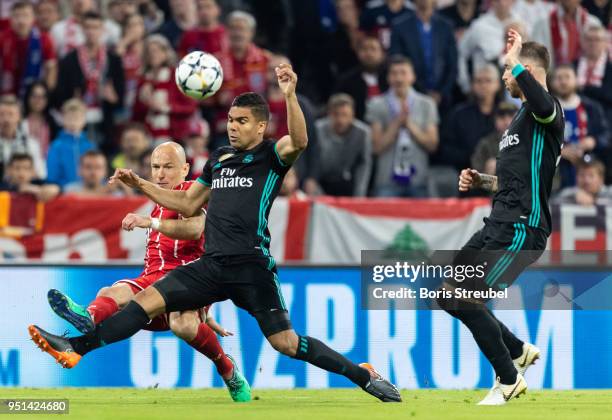 Arjen Robben of FC Bayern Muenchen is challenged by Casemiro of Real Madrid during the UEFA Champions League Semi Final First Leg match between...