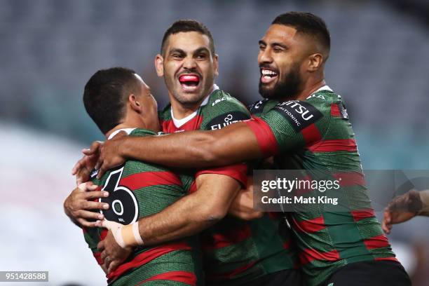 Cody Walker of the Rabbitohs celebrates with Greg Inglis and Robert Jennings after scoring the first try in the NRL round eight match between the...