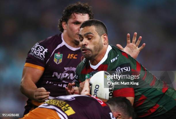 Greg Inglis of the Rabbitohs is tackled in the NRL round eight match between the South Sydney Rabbitohs and the Brisbane Broncos at ANZ Stadium on...