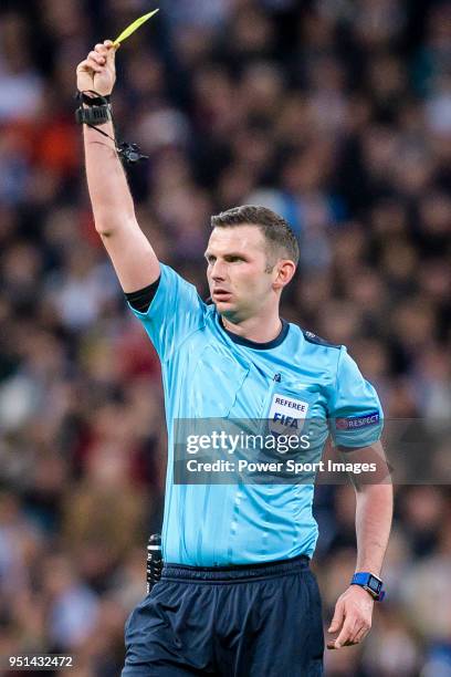 Referee Michael Oliver issues yellow card during the UEFA Champions League 2017-18 quarter-finals match between Real Madrid and Juventus at Estadio...