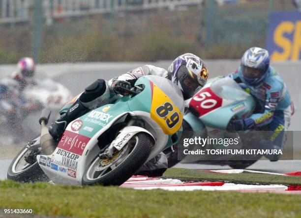 Japanese wild card rider Osamu Miyazaki leads Daisaku Sakai and Hiroshi Aoyama of Japan during the 250cc-class season opener, Japanese Grand Prix in...