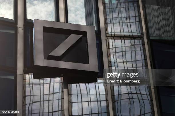 The Deutsche Bank AG logo sits on an office building in Frankfurt, Germany, on Wednesday, April 25, 2018. Germanys largest lender will scale back...