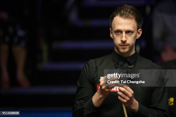 Judd Trump of England chalks the cue in his first round match against Chris Wakelin of England on day five of the World Snooker Championship at...