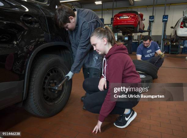 The Girls'Day - Girls Future Day, takes place annually since 2001. The photo shows the girl Lisa and boy Tim at work on a car tire in a car repair...