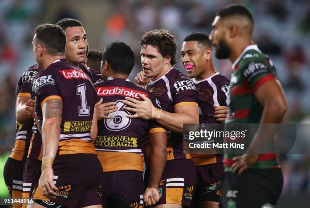 James Roberts of the Broncos celebrates with team mates after scoring a try during the NRL round eight match between the South Sydney Rabbitohs and...