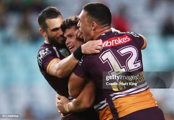 James Roberts of the Broncos celebrates with team mates after scoring a try during the NRL round eight match between the South Sydney Rabbitohs and...