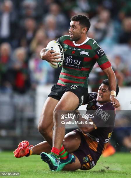 Alex Johnston of the Rabbitohs is tackled by Anthony Milford of the Broncos during the NRL round eight match between the South Sydney Rabbitohs and...