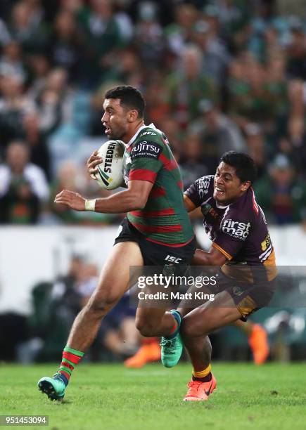 Alex Johnston of the Rabbitohs is tackled by Anthony Milford of the Broncos during the NRL round eight match between the South Sydney Rabbitohs and...