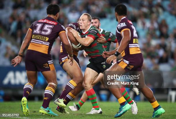 Jason Clark of the Rabbitohs is tackled during the NRL round eight match between the South Sydney Rabbitohs and the Brisbane Broncos at ANZ Stadium...