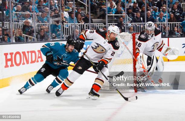 Francois Beauchemin of the Anaheim Ducks skates with the puck against Mikkel Boedker of the San Jose Sharks in Game Four of the Western Conference...