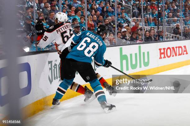 Melker Karlsson of the San Jose Sharks collides into Marcus Pettersson of the Anaheim Ducks in Game Four of the Western Conference First Round during...