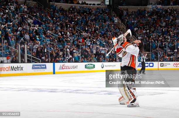 John Gibson of the Anaheim Ducks adjusts his helmet during the game against the San Jose Sharks in Game Four of the Western Conference First Round...