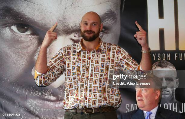 Tyson Fury poses as promoter Frank Warren looks on during a press conference on April 26, 2018 at the Lowry Hotel in Manchester, England. Fury is due...