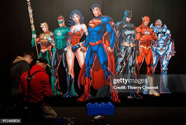 Comics universe poster: Batman, Superman, Wonder Woman, The Joker is displayed during the press preview of the exhibition "The Art of the Brick: DC...