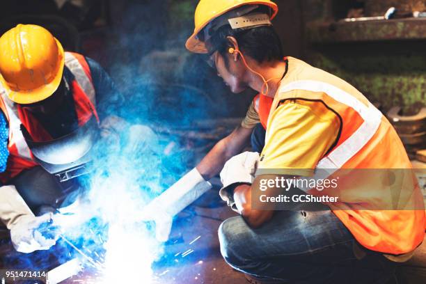 pointing out where to focus on the welding - ear plug stock pictures, royalty-free photos & images