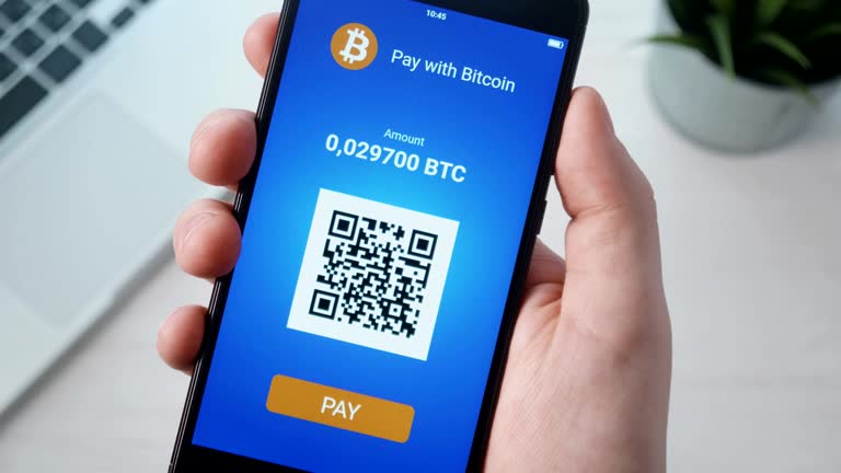 https://media.gettyimages.com/id/951471442/video/paying-with-bitcoin-using-smartphone.jpg?b=1&s=640x640&k=20&c=PNNikl2EsDWUbo-2xUNtLBn6twIU4LyuTIInB5lja-8=