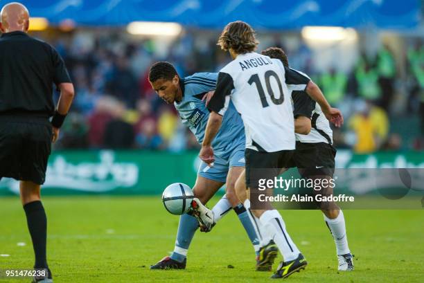 Sylvain N'Diaye of Marseille, Angel Angulo of Valencia and Ruben Baraja of Valencia of Marseille during the Uefa cup final match between Valencia and...