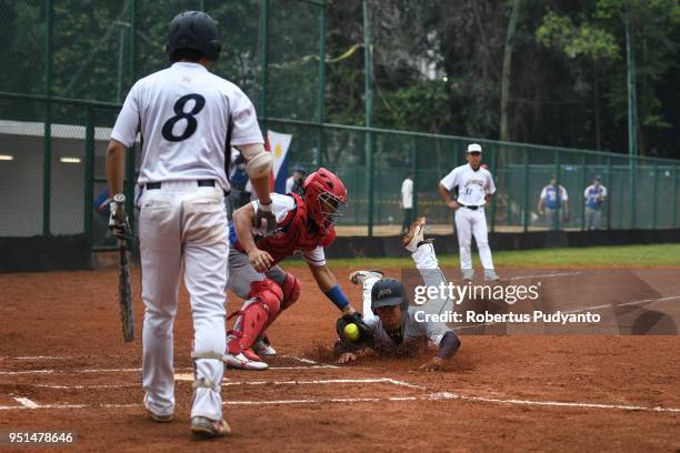 Yuto Nakajima of Japan slides during the qualification match between Japan and Philippines in the 10th Asian Men's Softball Championship on April 26,...