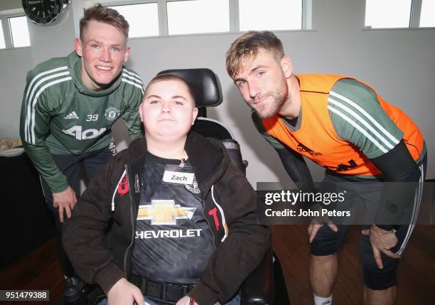 Scott McTominay and Luke Shaw of Manchester United pose with Zach during the MU Foundation Dream Day at Aon Training Complex on April 26, 2018 in...