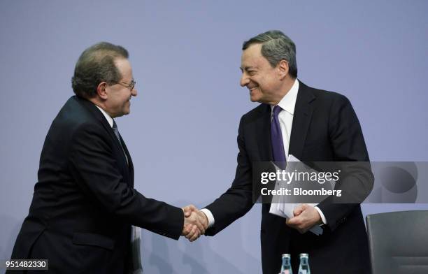 Mario Draghi, president of the European Central Bank , right, shakes hands with Vitor Constancio, vice president of the European Central Bank , at...