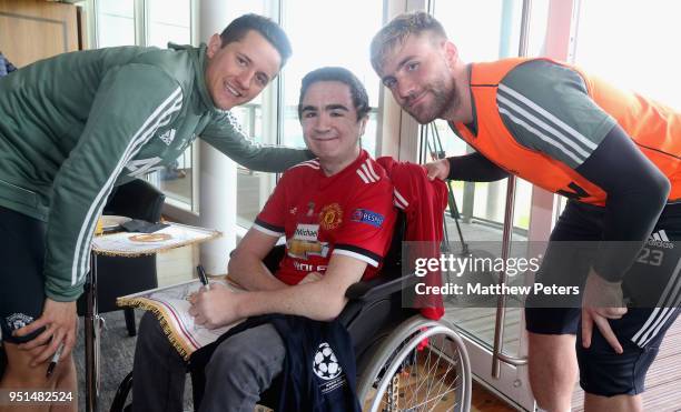 Ander Herrera and Luke Shaw of Manchester United pose with Michael during the MU Foundation Dream Day at Aon Training Complex on April 26, 2018 in...