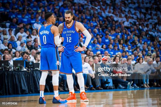 Russell Westbrook and Steven Adams of the Oklahoma City Thunder talk on the court in Game Five against the Utah Jazz during Round One of the 2018 NBA...