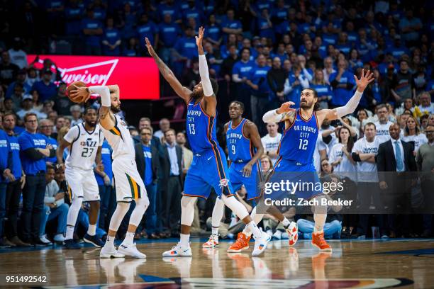 Ricky Rubio of the Utah Jazz looks to pass the ball while guarded by Paul George of the Oklahoma City Thunder in Game Five during Round One of the...