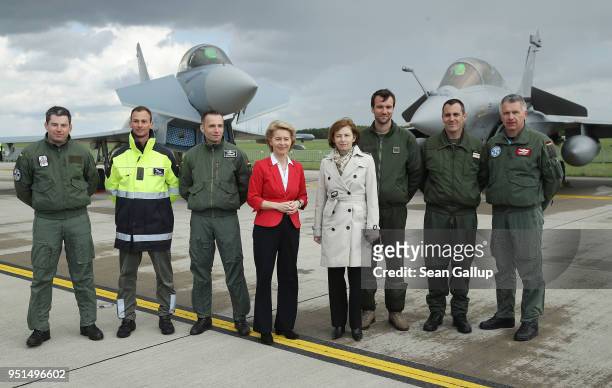 German Defense Minister Ursula von der Leyen and French Defense Minister Florence Parly stand with pilots next to a Eurofighter Typhoon and a...