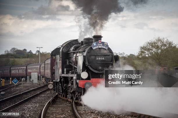 Historic 1920s 'Mogul' steam locomotive is coupled to a ten-carriage train, leaves Yeovil Junction near Yeovil on April 26, 2018 in Somerset,...