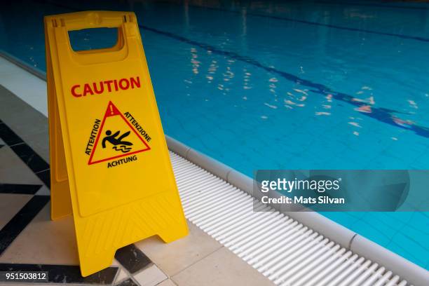 warning sign on the poolside - slippery stock-fotos und bilder
