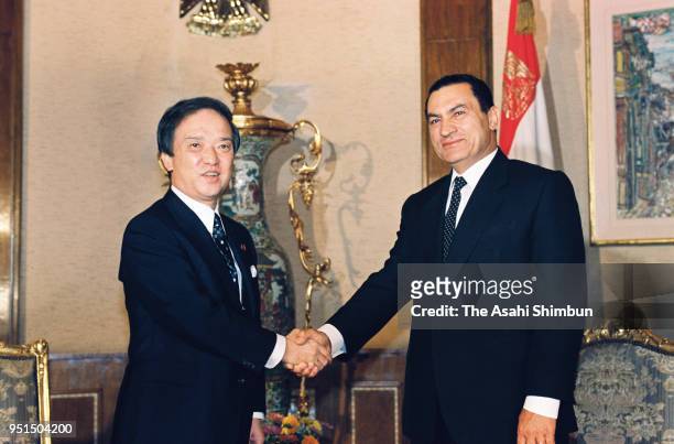 Japanese Prime Minister Toshiki Kaifu and Egyptian President Hosni Mubarak shake hands prior to their meeting at the presidential palace on October...