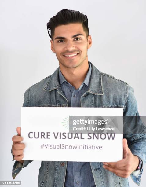 Marlon Aquino poses with Visual Snow Initiative wearing Moonstar Beauty at Visual Snow Initiative visits The Artists Project on April 25, 2018 in Los...