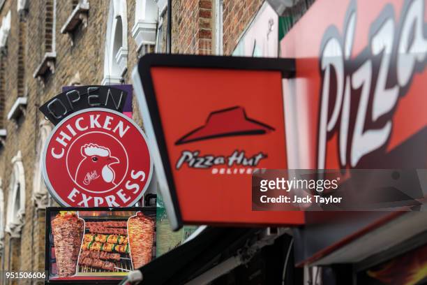 Signs on display outside fast food restaurants in Camberwell on April 26, 2018 in London, England. Party leaders have called on the Government to...