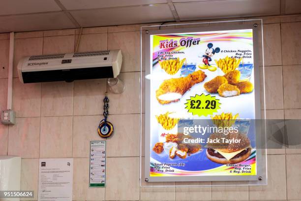 An advert for children's offers on display in a chicken shop in Camberwell on April 26, 2018 in London, England. Party leaders have called on the...