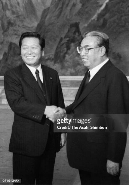 North Korean leader Kim Il-sung shakes hands with ruling Liberal Democratic Party lawmaker Ichiro Ozawa prior to the Workers' Party of Korea 45th...