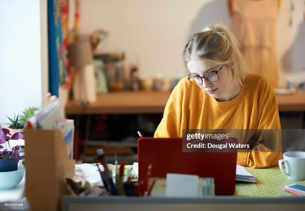 Female student at home studying.