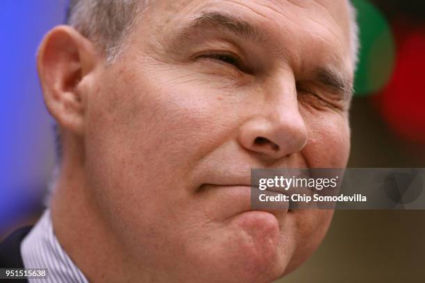 Environmental Protection Agency Administrator Scott Pruitt winks to lawmakers while testifying before the House Energy and Commerce Committee's...