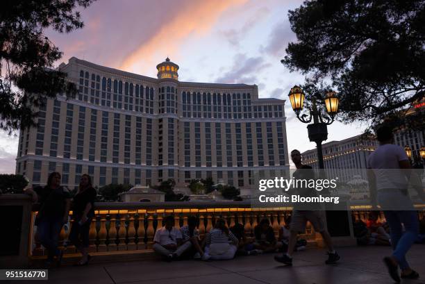 Pedestrians pass in front of the MGM Resorts International Bellagio Resort & Casino at dusk in Las Vegas, Nevada, U.S., on Wednesday, April 25, 2018....