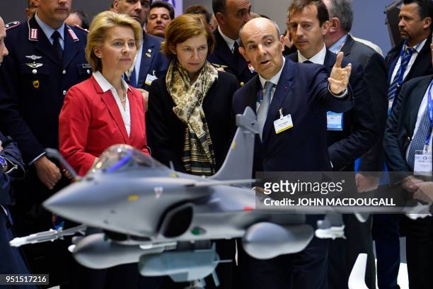 German Defence Minister Ursula von der Leyen and her French counterpart Florence Parly listen to Dassault Aviation Chief Executive Eric Trappier...