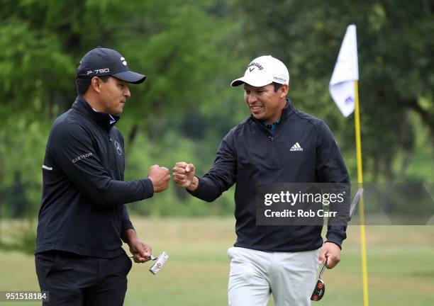 Andres Romero of Argentina and Fabian Gomez of Argentina celebrate a putt on the 15th hole during the first round of the Zurich Classic at TPC...