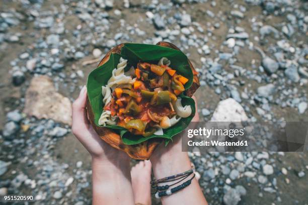hands holing cuban dish in a banana leaf - holing hands stock pictures, royalty-free photos & images