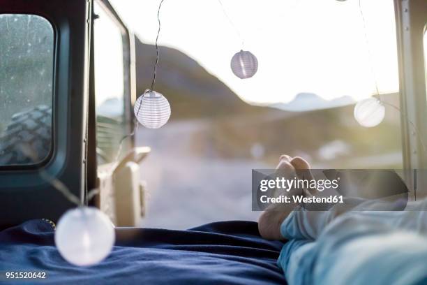 italy, piemont, colle basset, young man lying in land rover - land rover stock pictures, royalty-free photos & images