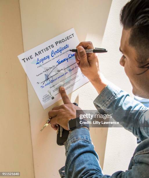 Marlon Aquino poses with Legacy Certificate at Visual Snow Initiative visits The Artists Project on April 25, 2018 in Los Angeles, California.