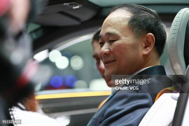 Li Shufu, chairman of Zhejiang Geely Holding Group Co. Sits inside a Polestar 1 electric vehicle during the Auto China 2018 at China International...