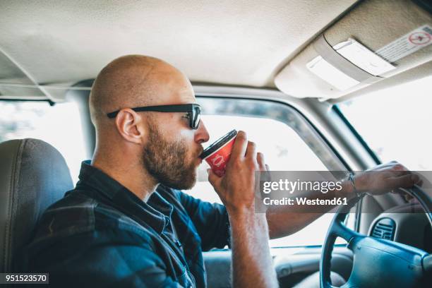 young man with sunglasses and beard on a road trip with takeaway drink - bald people stock pictures, royalty-free photos & images