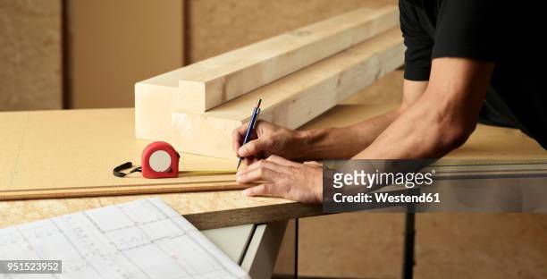 worker marking wood with pencil, tape measure - length stock pictures, royalty-free photos & images