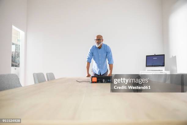 confident businessman in conference room preparing a presentation - lead stock-fotos und bilder